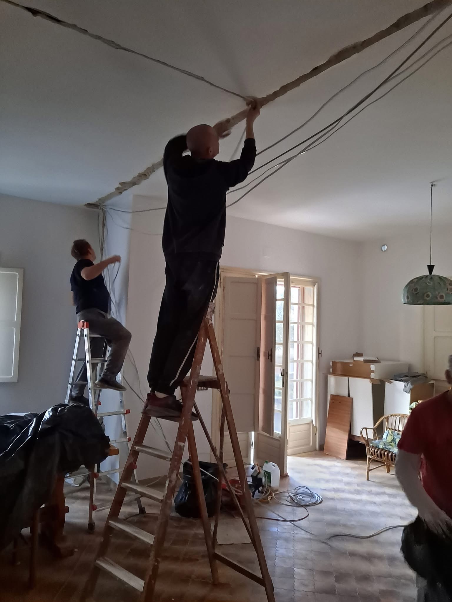 Work on cables beneath the ceiling during a home renovation