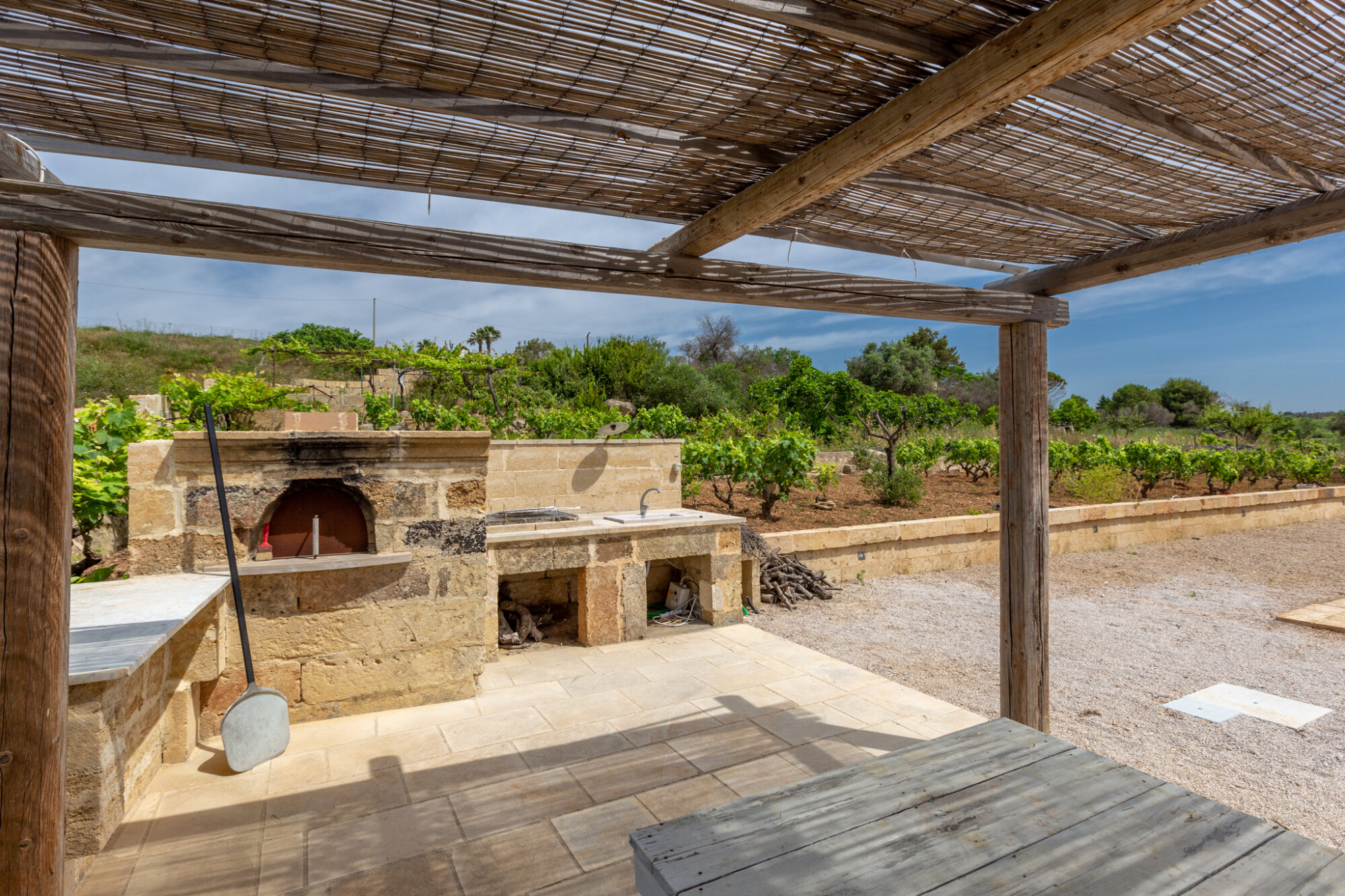Barbecue and pizza oven by the covered pergola