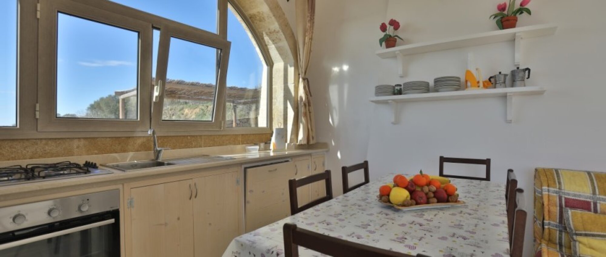 Kitchen and dining area beneath a stone arch
